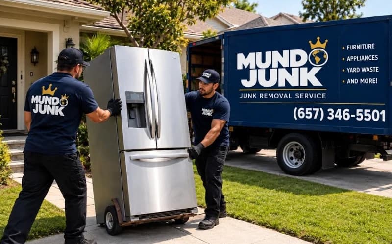 Mundo Junk Removal & Recycling crew moving a refrigerator out to the truck