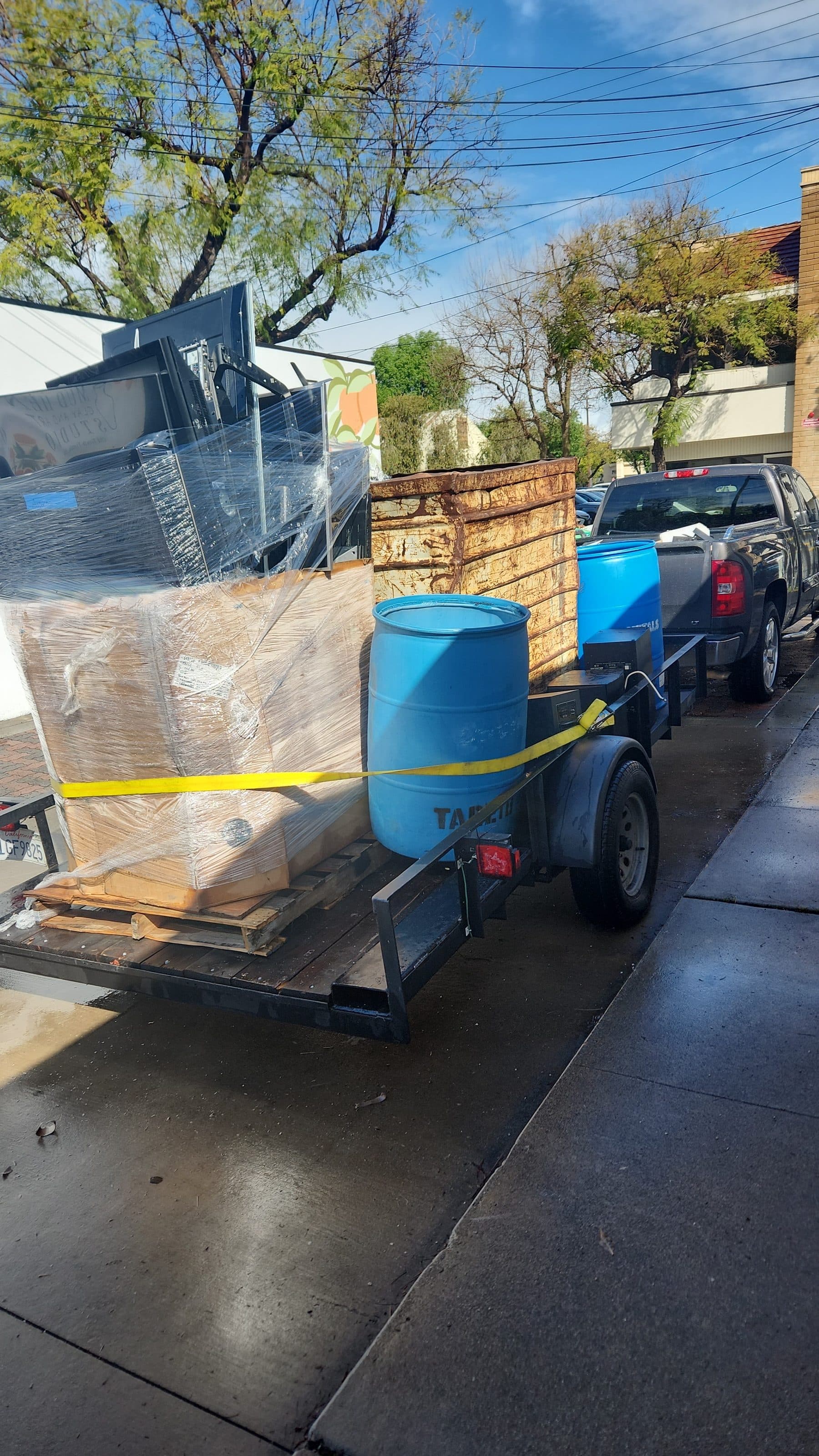 Trailer loaded with electronics and recycling barrels