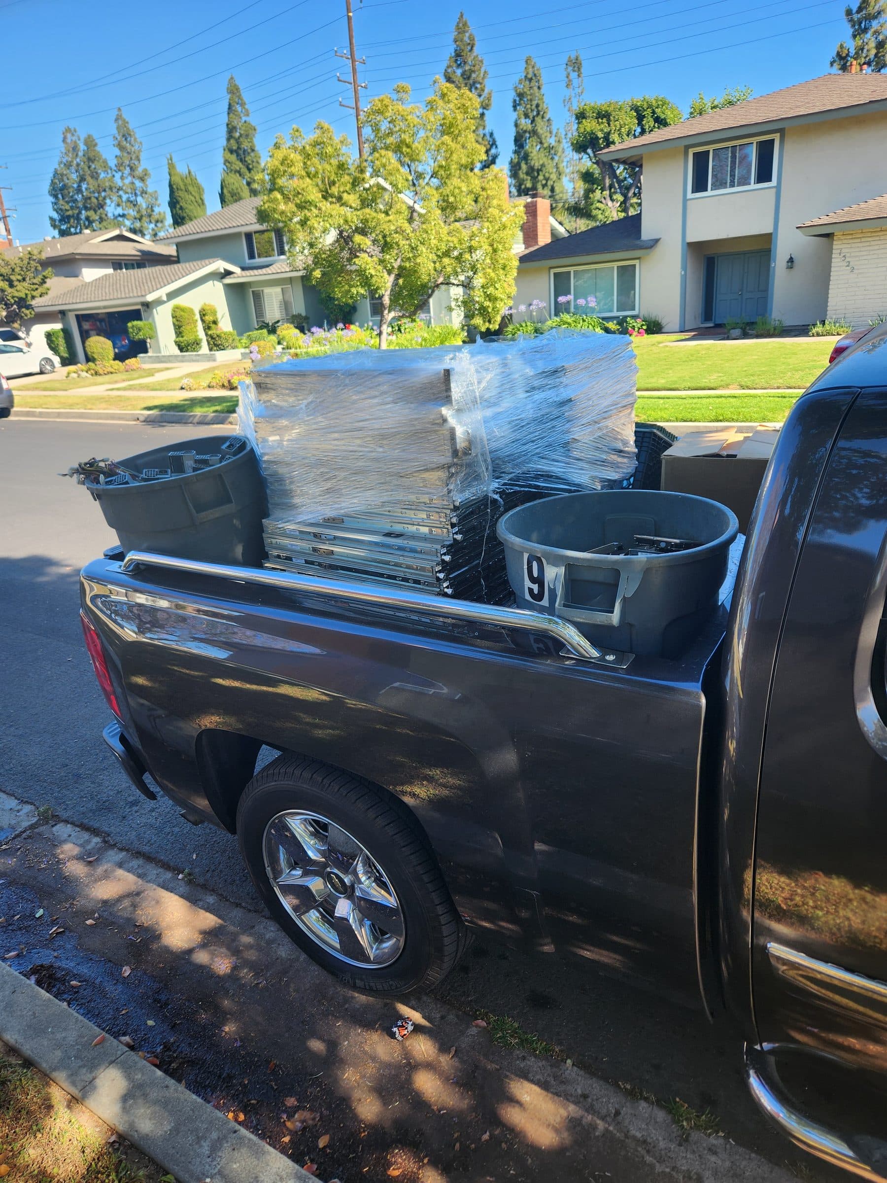 Mundo Junk Removal & Recycling truck bed loaded with furniture and junk ready for haul-away
